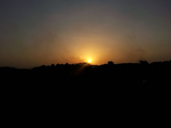 Silhouette landscape against sky during sunset