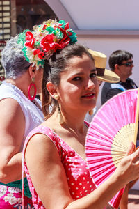 Portrait of happy woman with arms raised