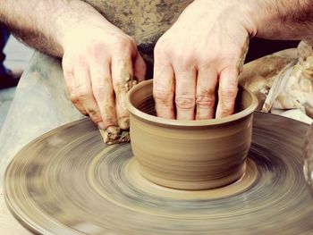 Close-up of man making a pot