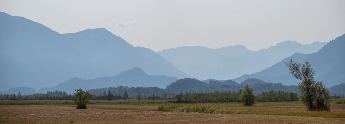 Scenic view of field and mountains against sky