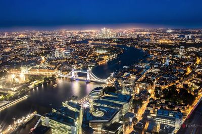 High angle view of illuminated city buildings at night