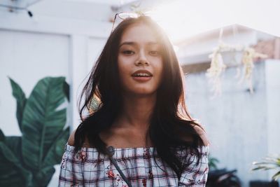 Portrait of beautiful young woman standing outdoors