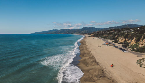 Panoramic view of beach against clear blue sky