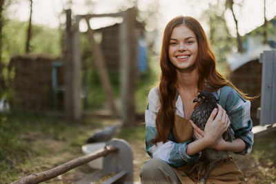 Portrait of young woman sitting on field