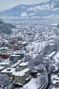 Aerial view of townscape and snowcapped mountains