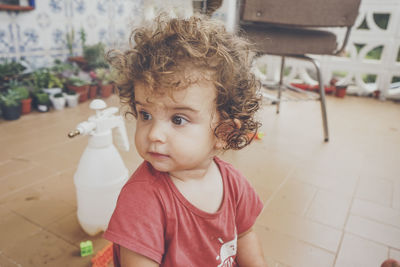 Cute girl sitting on floor at home