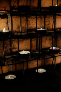 Illuminated candles on table in building