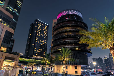 Illuminated buildings in city at night