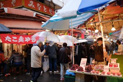 People at market stall in city