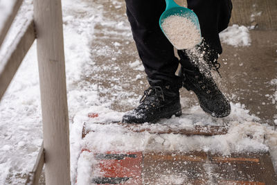 Low section of man standing on snow