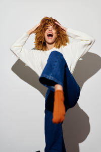 Portrait of woman with umbrella against white background