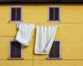 Low angle view of clothes drying against building