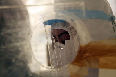 Close-up of doctor wearing protective suit