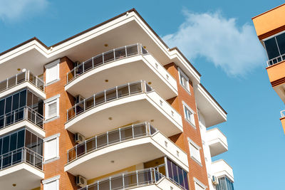 Balconies and blue sky with clouds. part of a residential building in turkey. 