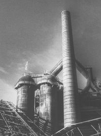 Low angle view of factory against sky