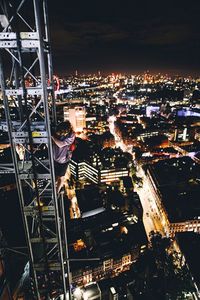 Illuminated cityscape against sky at night