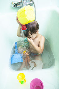 High angle view of shirtless boy in water