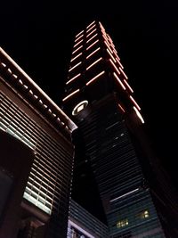 Low angle view of illuminated skyscraper against clear sky