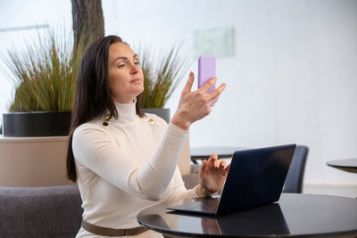 Young woman using laptop at home