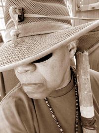 Close-up of woman wearing hat at home