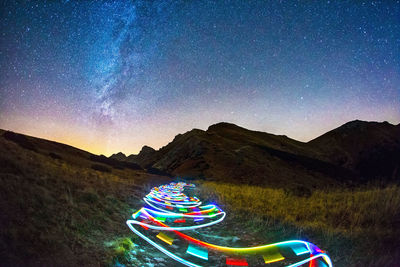 Light painting on mountain against sky at night