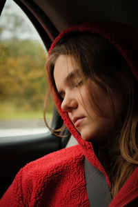 Close-up of woman relaxing in car