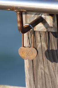 Close-up of love lock hanging on metal