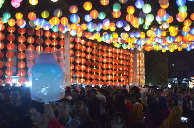 Group of people during traditional festival on street at night