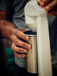 Midsection of man preparing refreshment drink