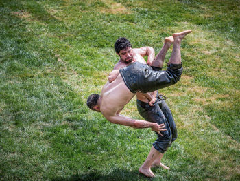 High angle view of man skateboarding on field