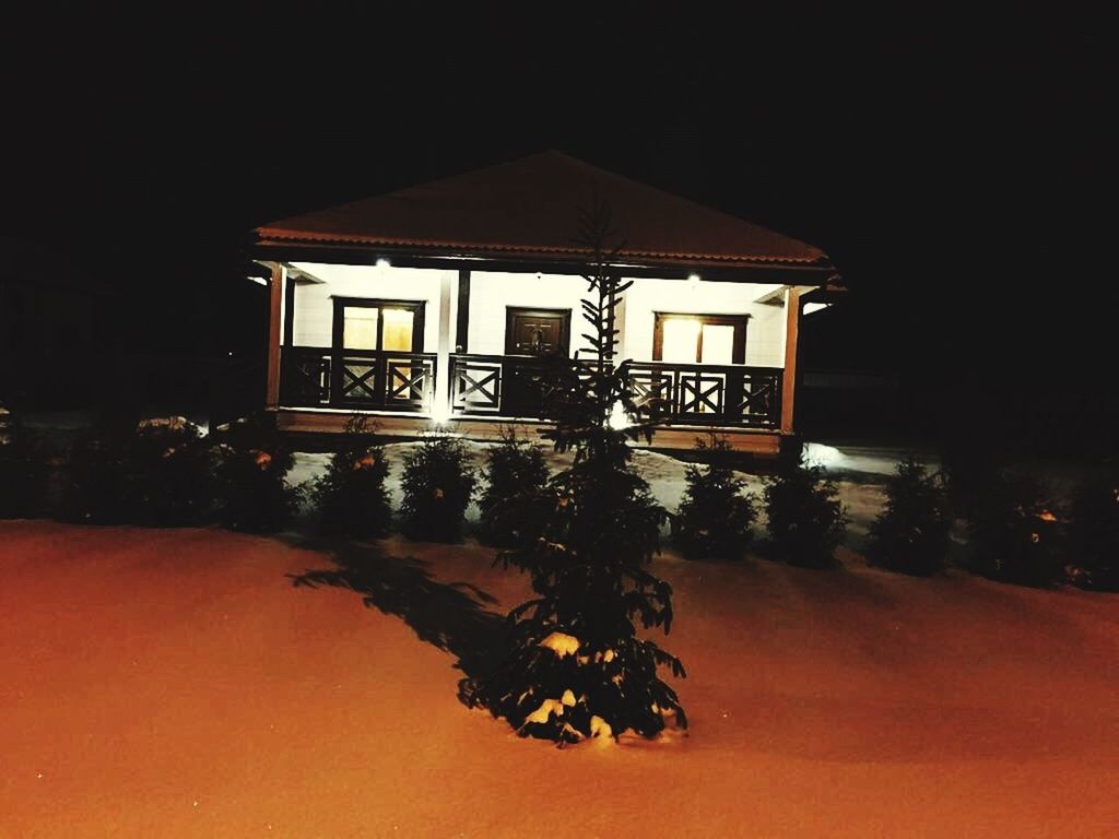 VIEW OF ILLUMINATED BUILDING AGAINST SKY AT NIGHT