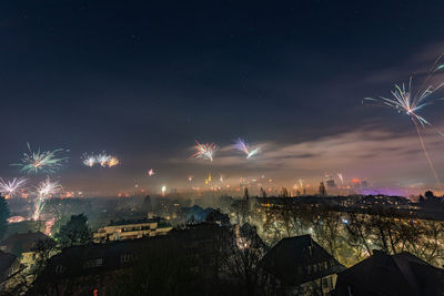 Aerial view of illuminated city against sky at night