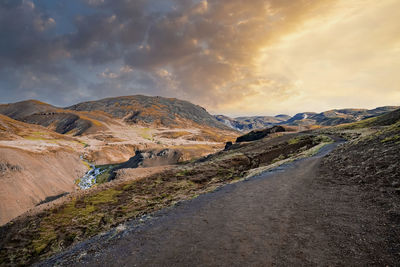 Scenic view of hot streams amidst landscape in hveragerdi valley during sunset