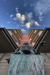 Low angle view of sculpture against building