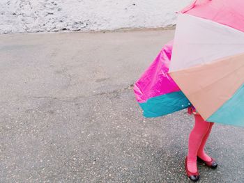 Boy on multi colored umbrella