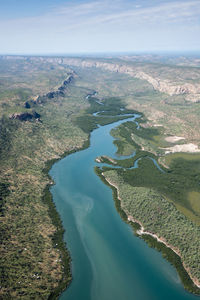 High angle view of river amidst trees against sky