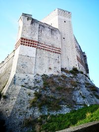 Low angle view of old building against blue sky