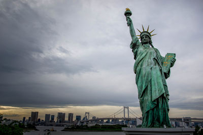 Statue of liberty against cloudy sky