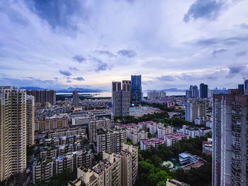 High angle view of modern buildings in city against sky
