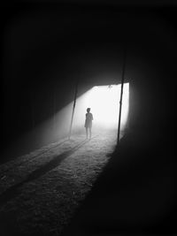 Woman standing in darkroom
