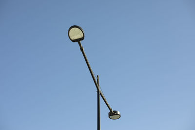 Pole with lamp against sky. lighting fixture in city. infrastructure details.
