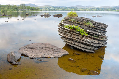 Scenic view of rock by lake