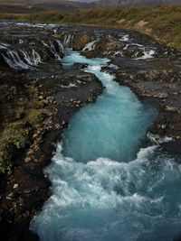 High angle view of water flowing through rocks