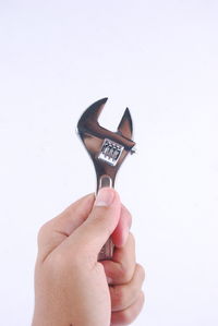 Close-up of woman hand against white background