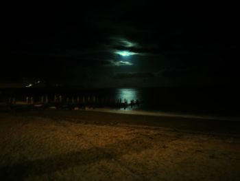 Scenic view of beach against sky at night