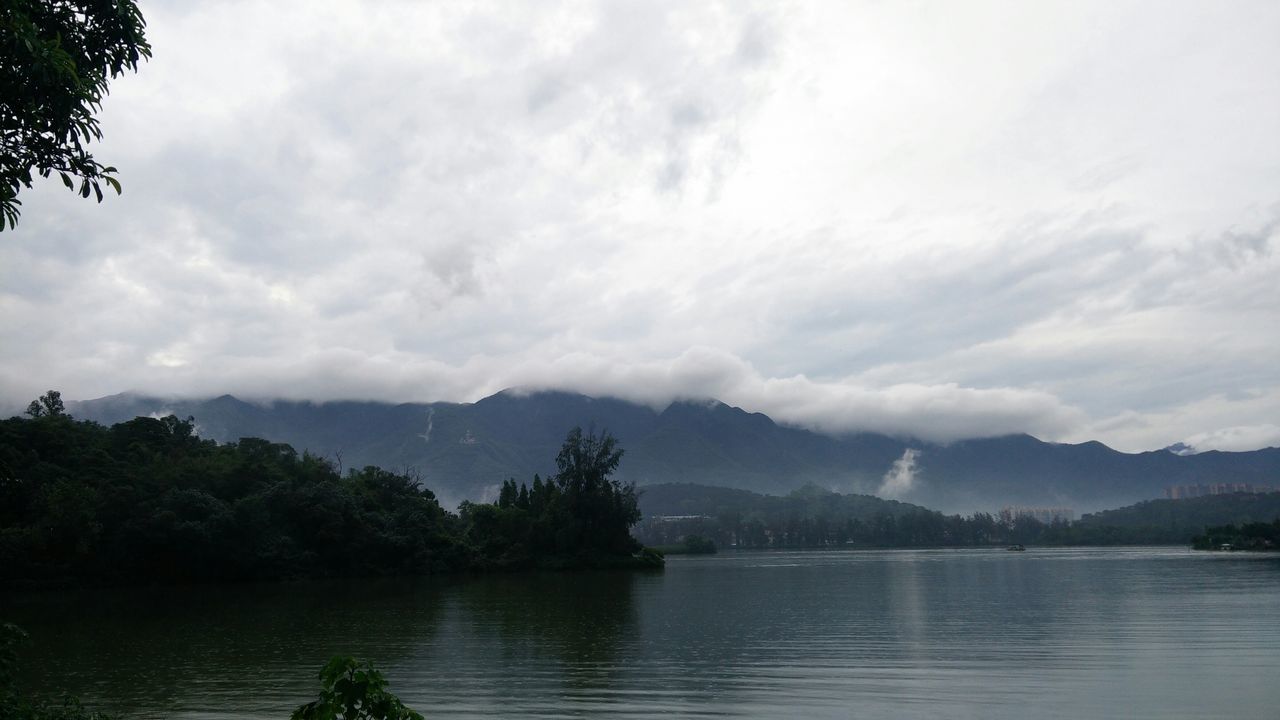 mountain, sky, water, tranquil scene, tranquility, lake, scenics, cloud - sky, beauty in nature, mountain range, cloudy, waterfront, tree, nature, cloud, river, idyllic, reflection, overcast, non-urban scene