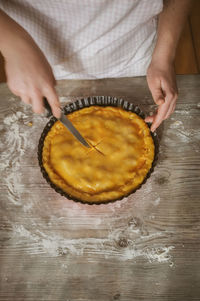 Cropped image of woman preparing apple pie