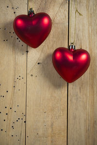 Close-up of red heart shape hanging on table