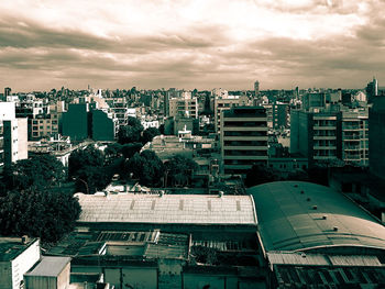 Cityscape against cloudy sky