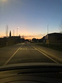 Road against sky seen through car windshield